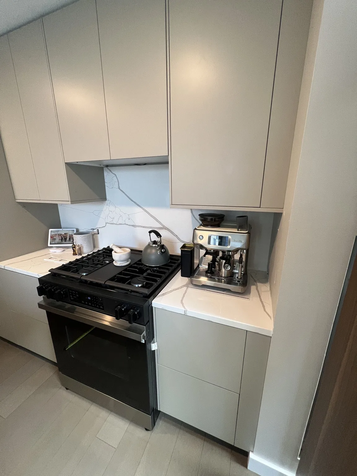 Modern IKEA kitchen with quartz countertops and gas range