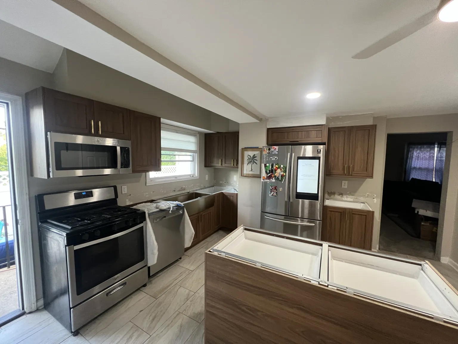 Walnut IKEA kitchen installation in progress with island base cabinets